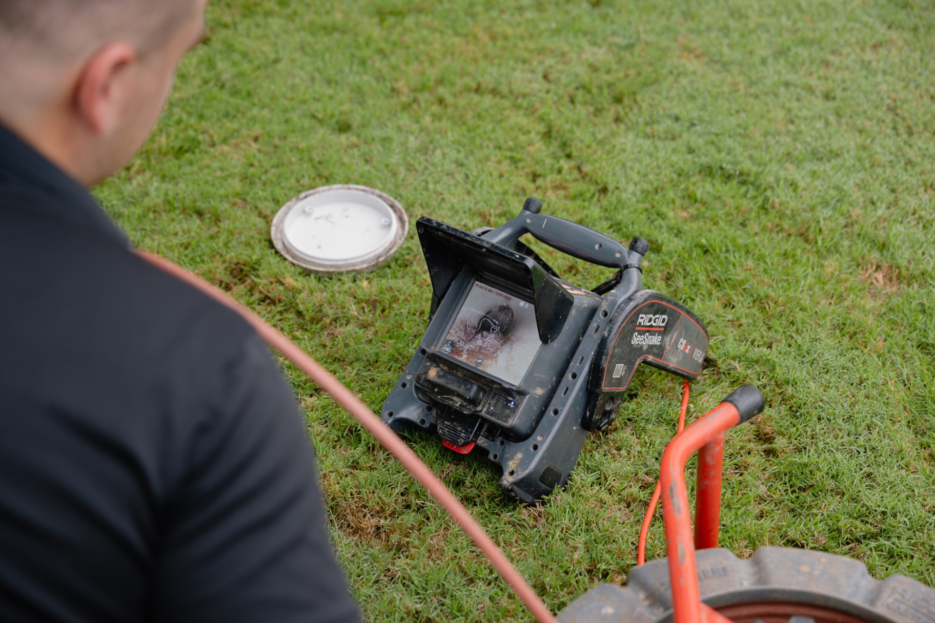 Reactive plumber CCTV-inspecting a blocked drain